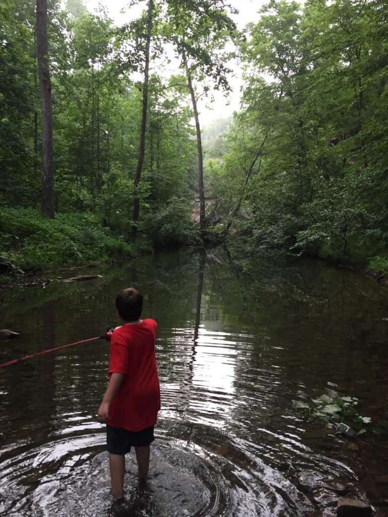 Scout fishing in creek. Parenting through the scout laws.