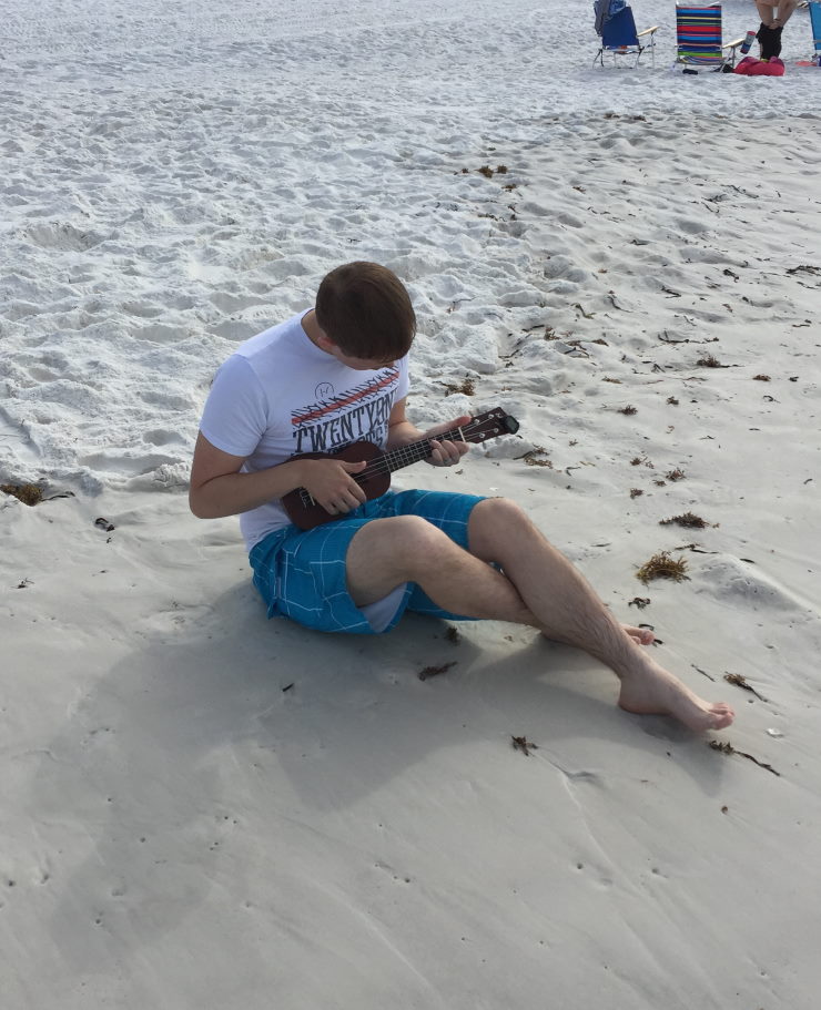 How to be a better father to your teenage son
Son playing the ukelele on the beach