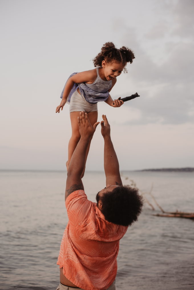 Father throwing daughter in air