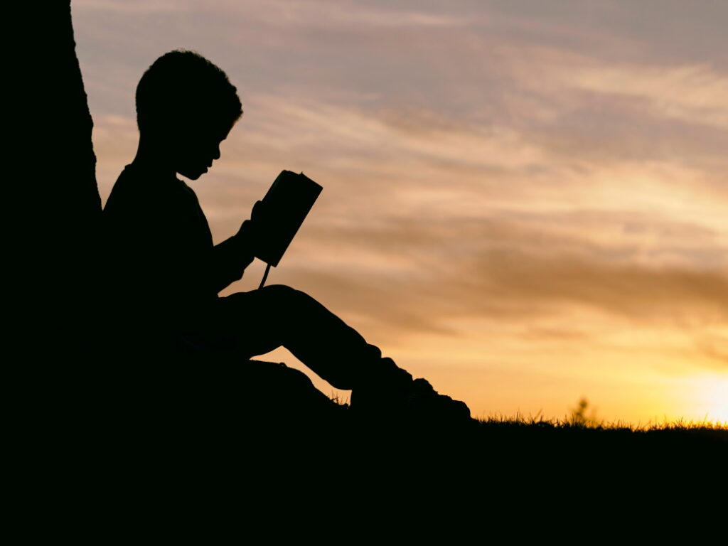 Child reading at sunset - set goals - Active Parenting styles